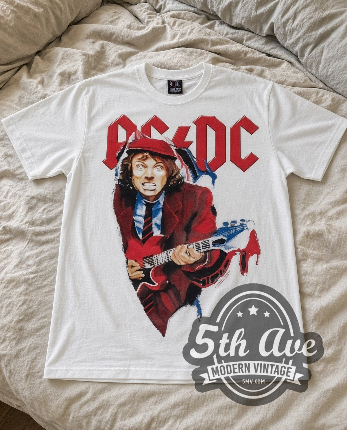 AC/DC Angus Suit vintage band t-shirt in white laid flat on a bed, front artwork