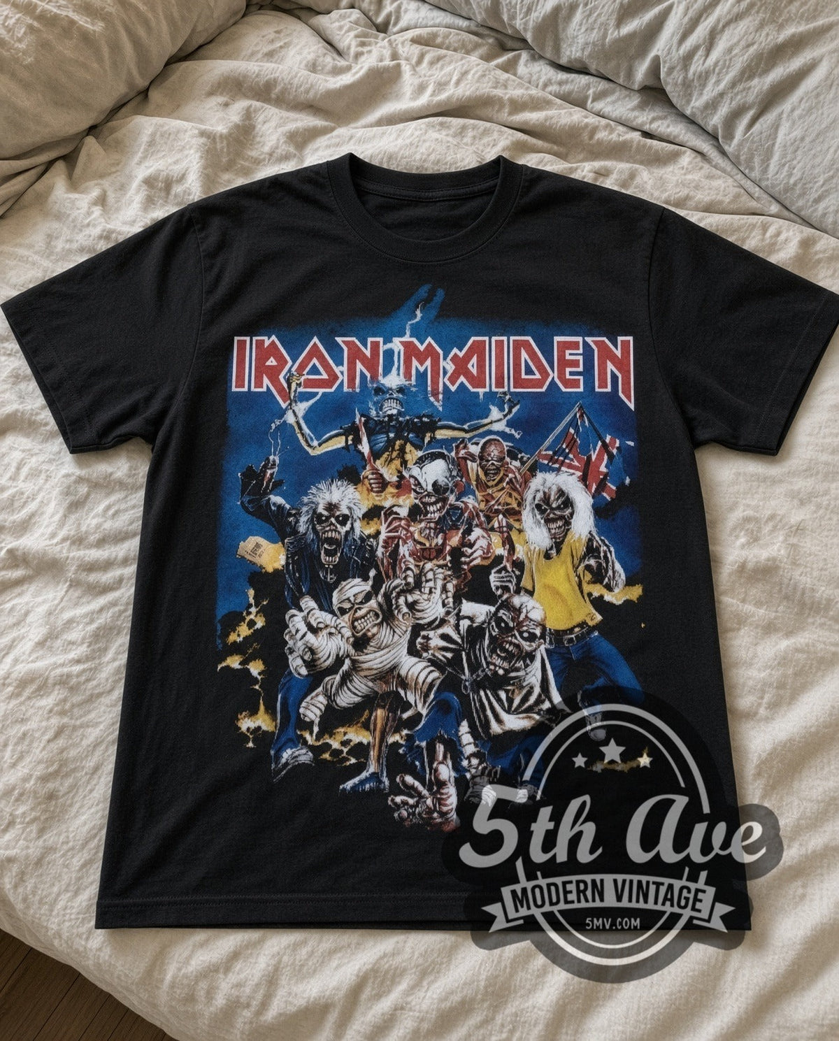 Iron Maiden Character Collage vintage band t-shirt in black laid flat on a bed, front artwork