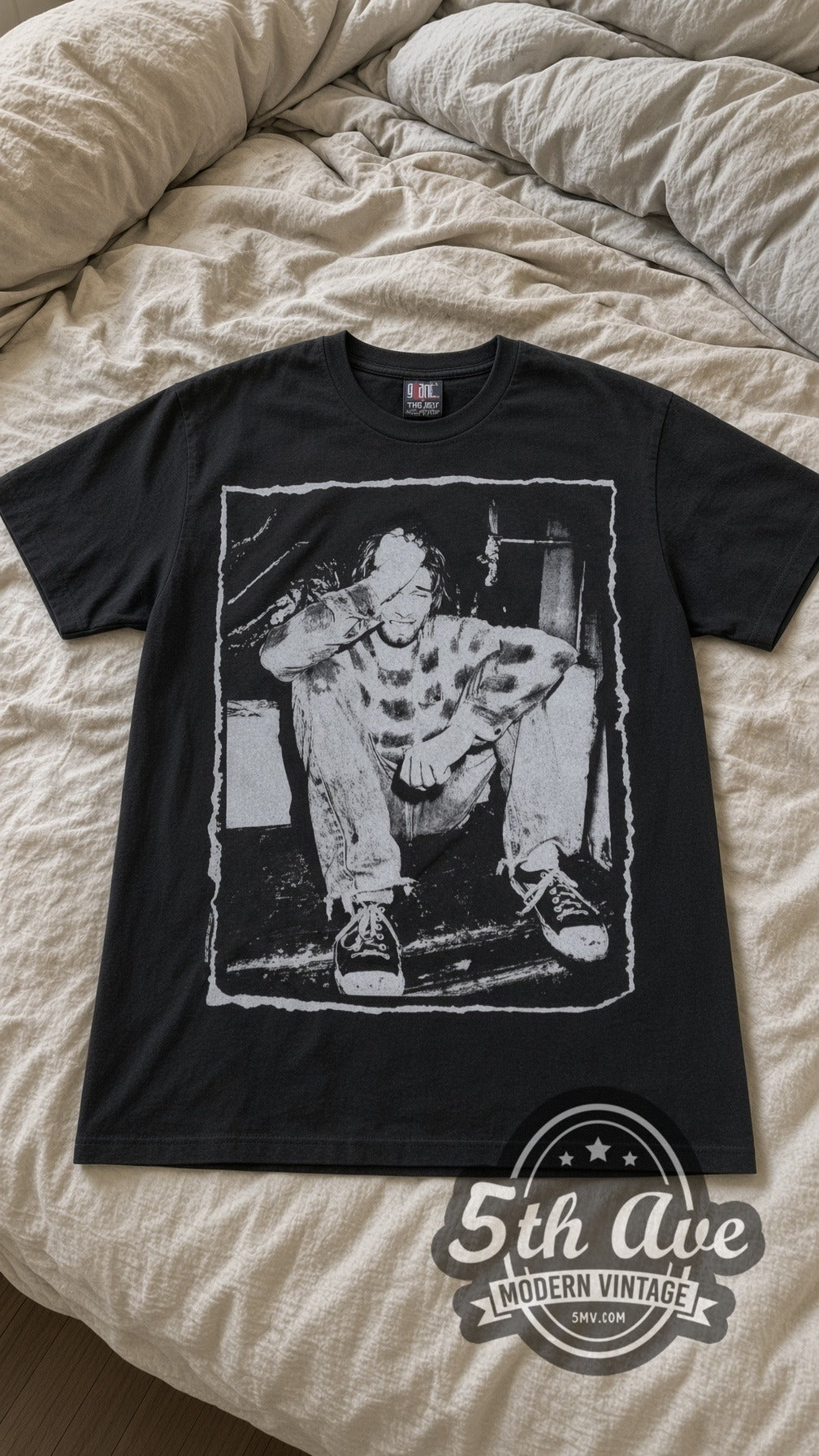 Kurt Cobain Chair vintage band t-shirt in black laid flat on a bed, front artwork