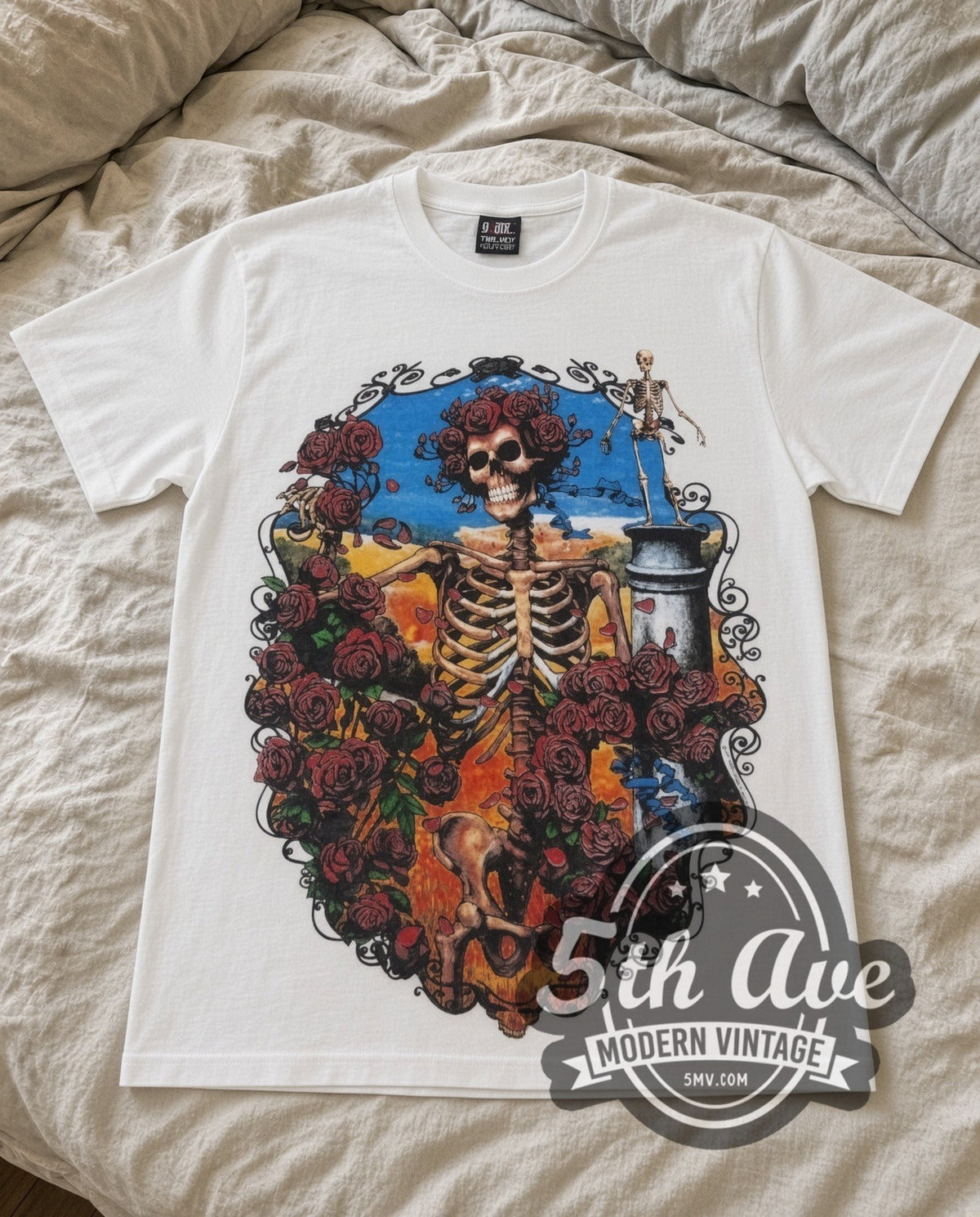 Grateful Dead Rose Skeleton vintage band t-shirt laid flat on a bed, front artwork