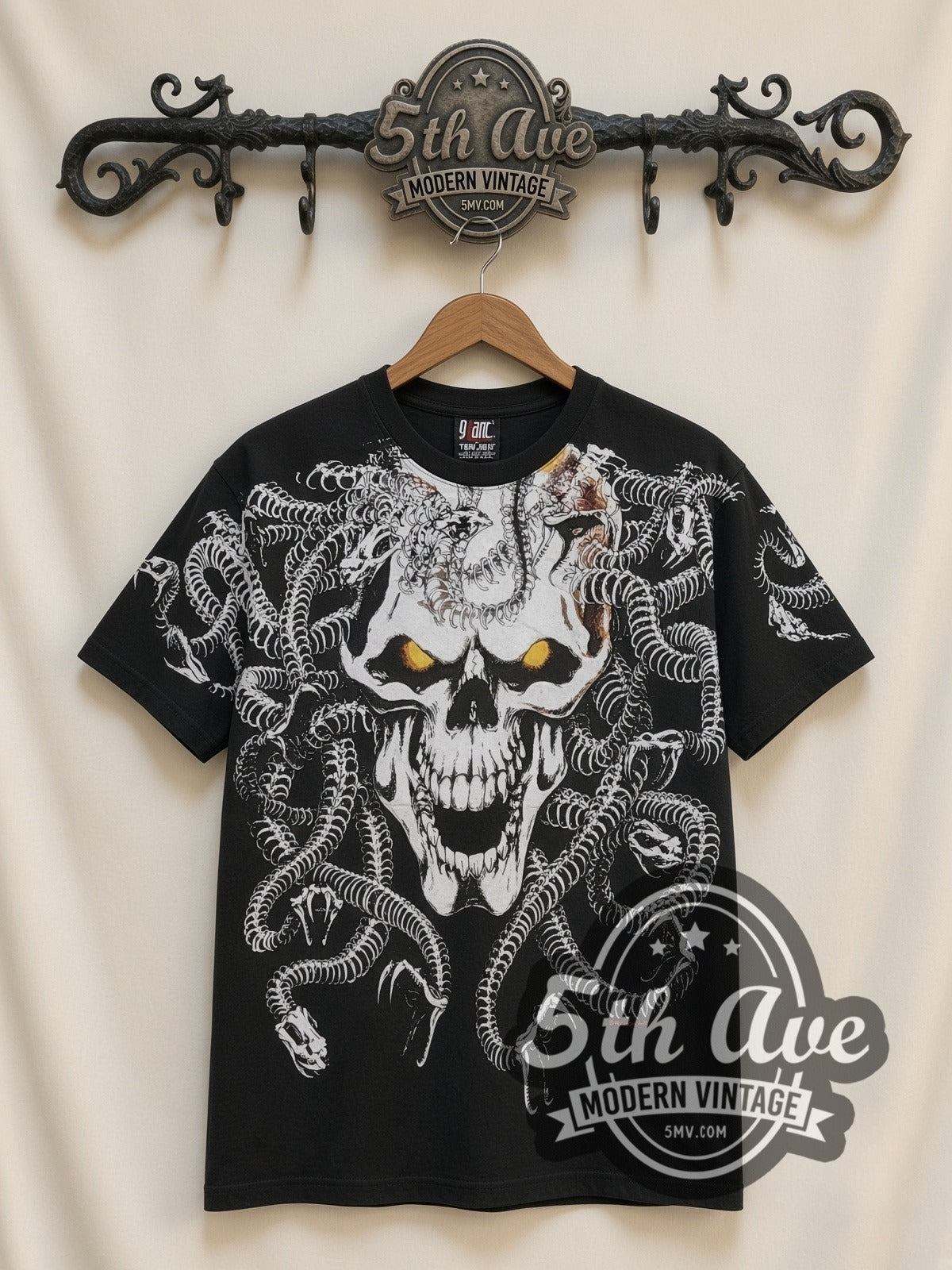 Medusa Snake Skull all-over-print vintage graphic tee in black, front view on a display rack