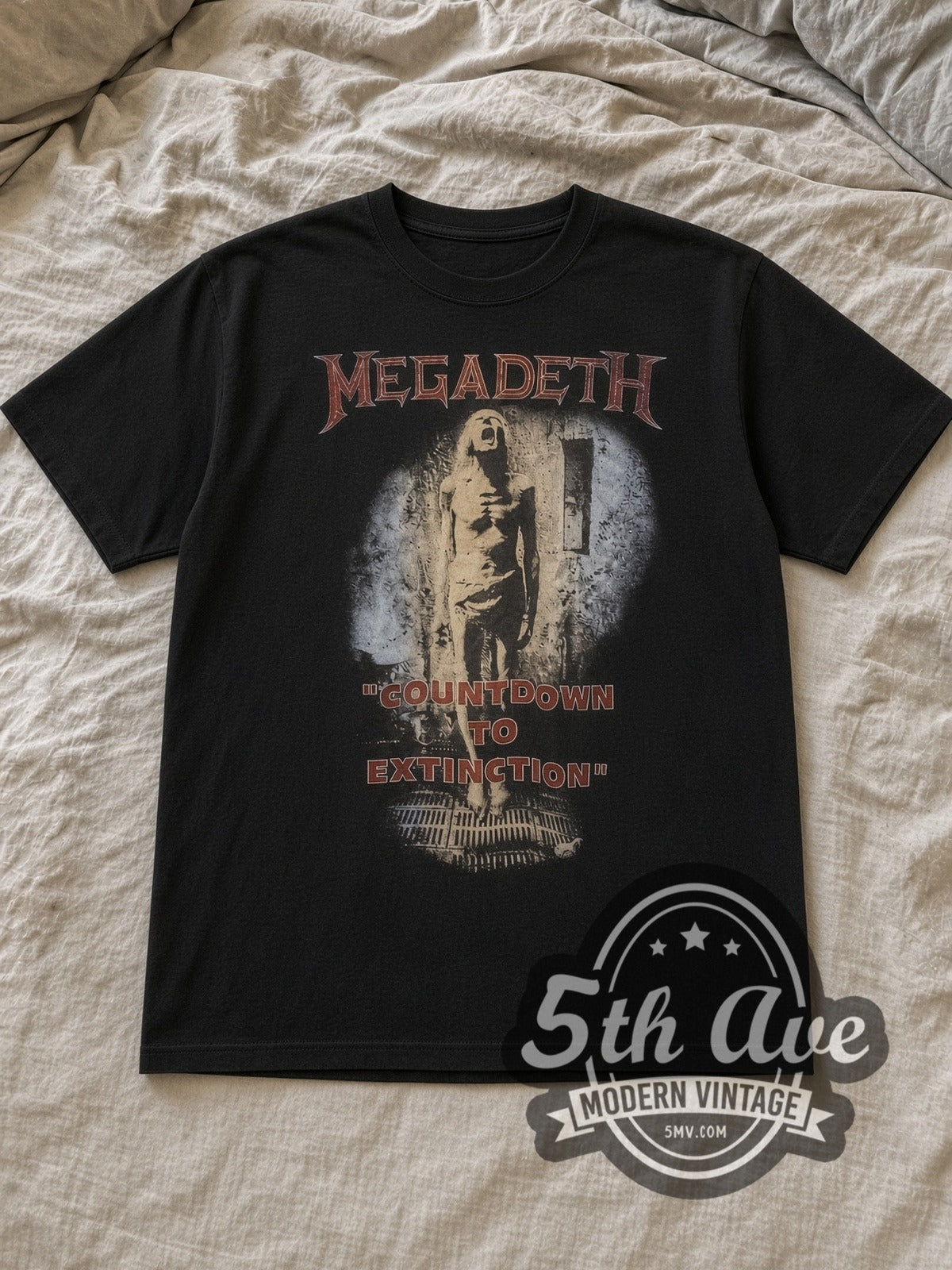 Black Megadeth Countdown to Extinction' Graphic Vintage Band T-Shirt laid flat on a linen bed