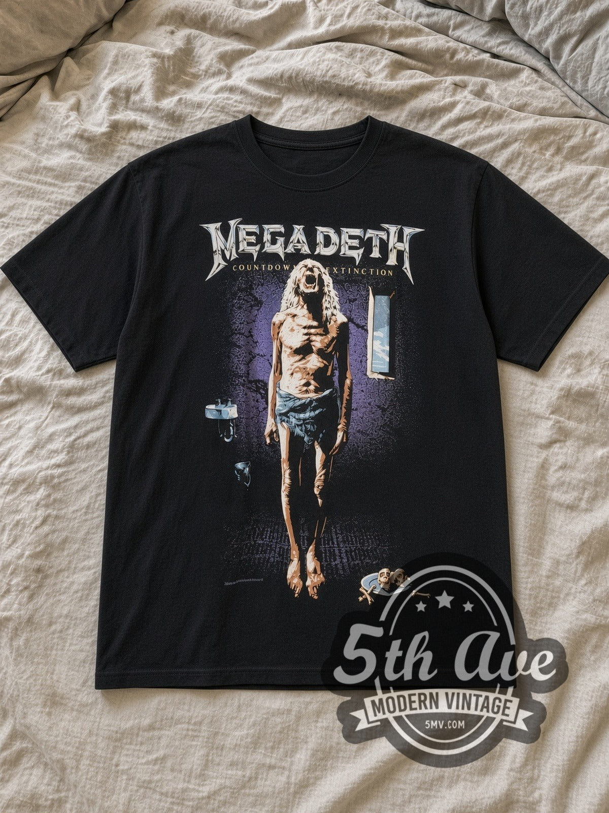 Black Megadeth Countdown to Extinction Vintage Band T-Shirt laid flat on a linen bed