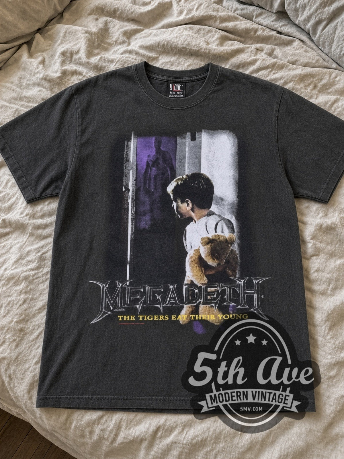 Megadeth Train of Consequences Globe band t-shirt in black laid flat on a bed, front artwork