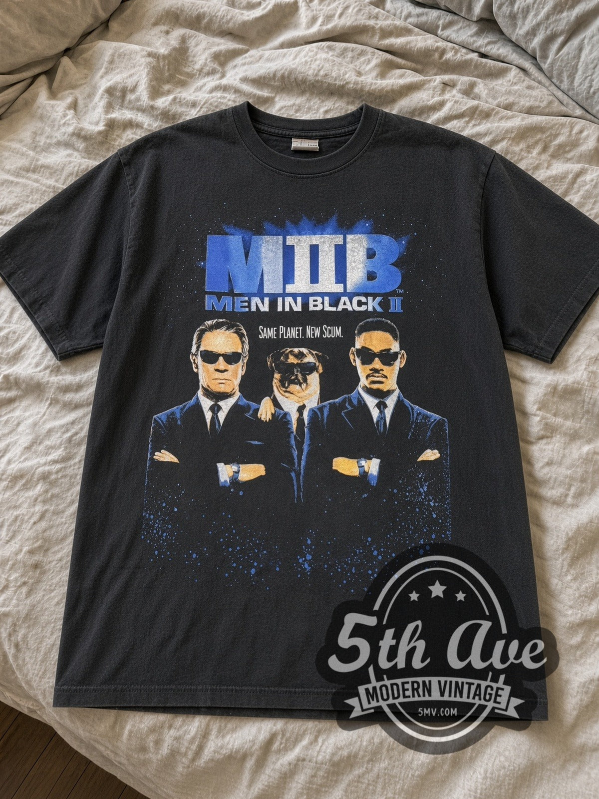 Black Men in Black II Same Planet New Scum and Egg Chairs tee laid flat on linen bed