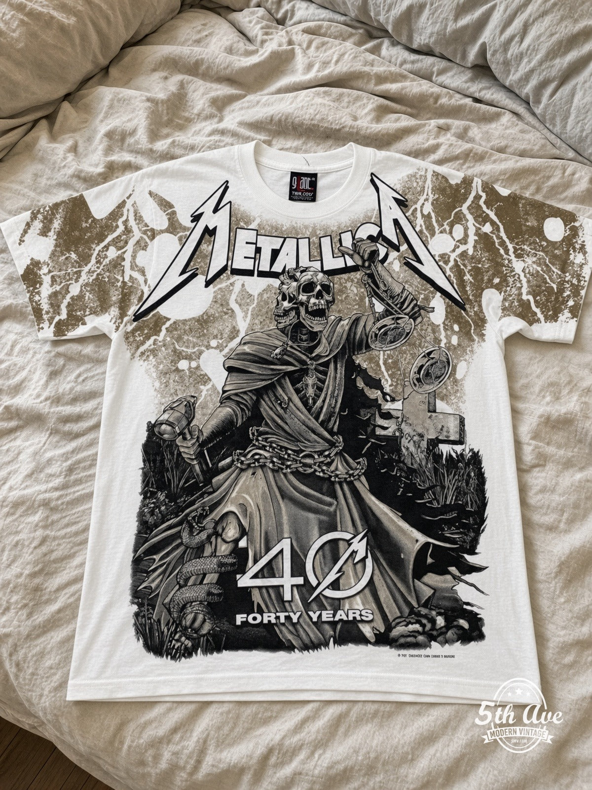 Metallica 40 Years Lady Justice White all over print vintage tee laid on bed