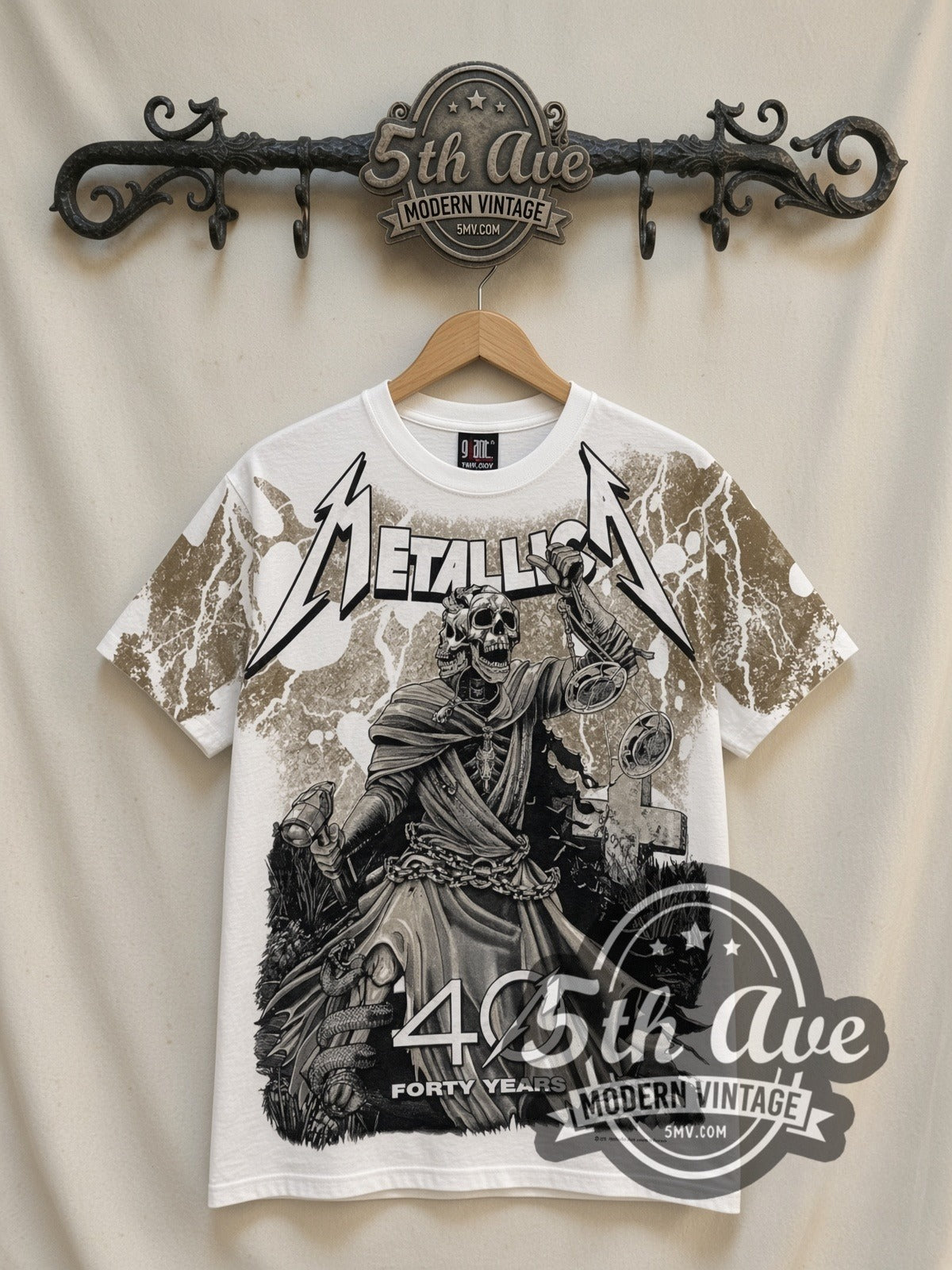 Metallica 40 Years Lady Justice all-over-print vintage band t-shirt in white, front view on a display rack