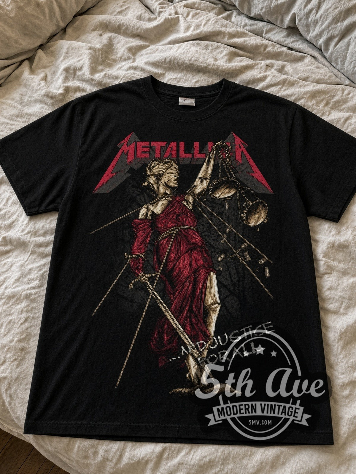 Metallica And Justice for All Lady Justice black graphic tee laid flat on linen bed