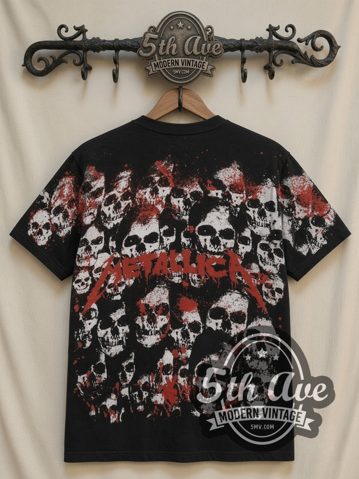 Metallica Band Portraits Skulls all-over-print vintage band t-shirt in black, back view on a display rack