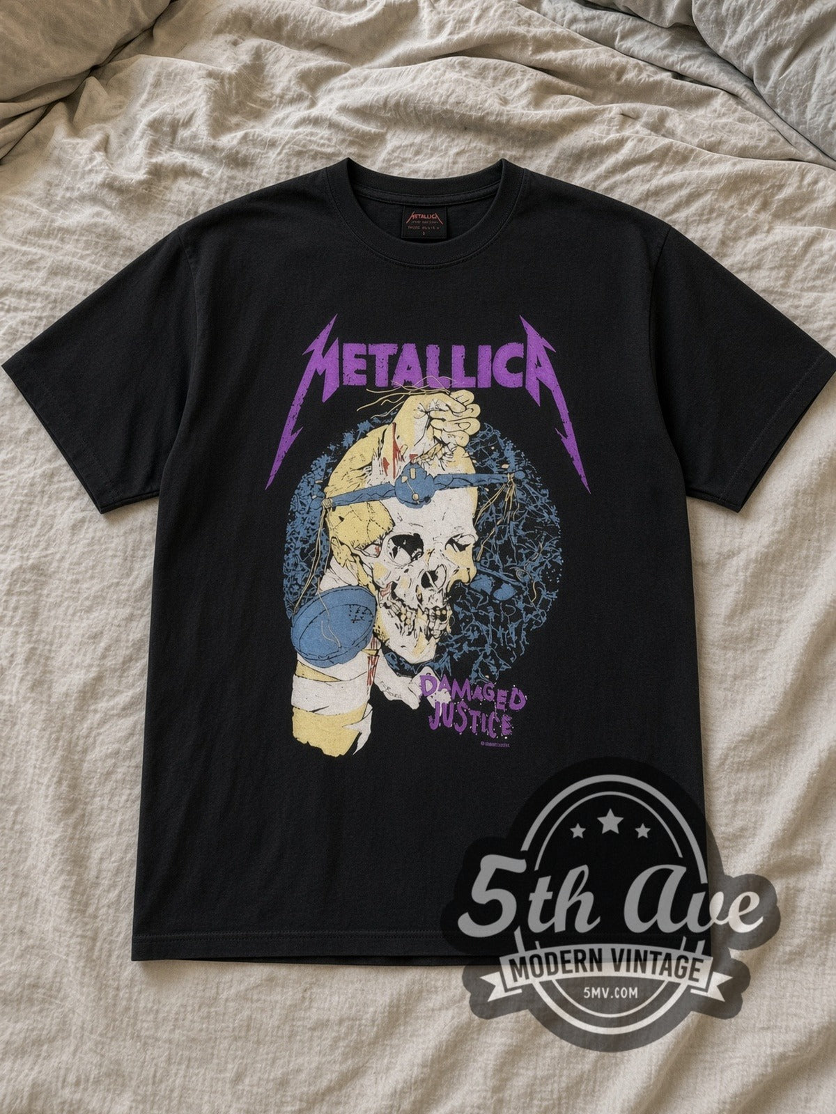 Black Metallica Damaged Justice Blindfold Scale Vintage Band T-Shirt laid flat on a linen bed