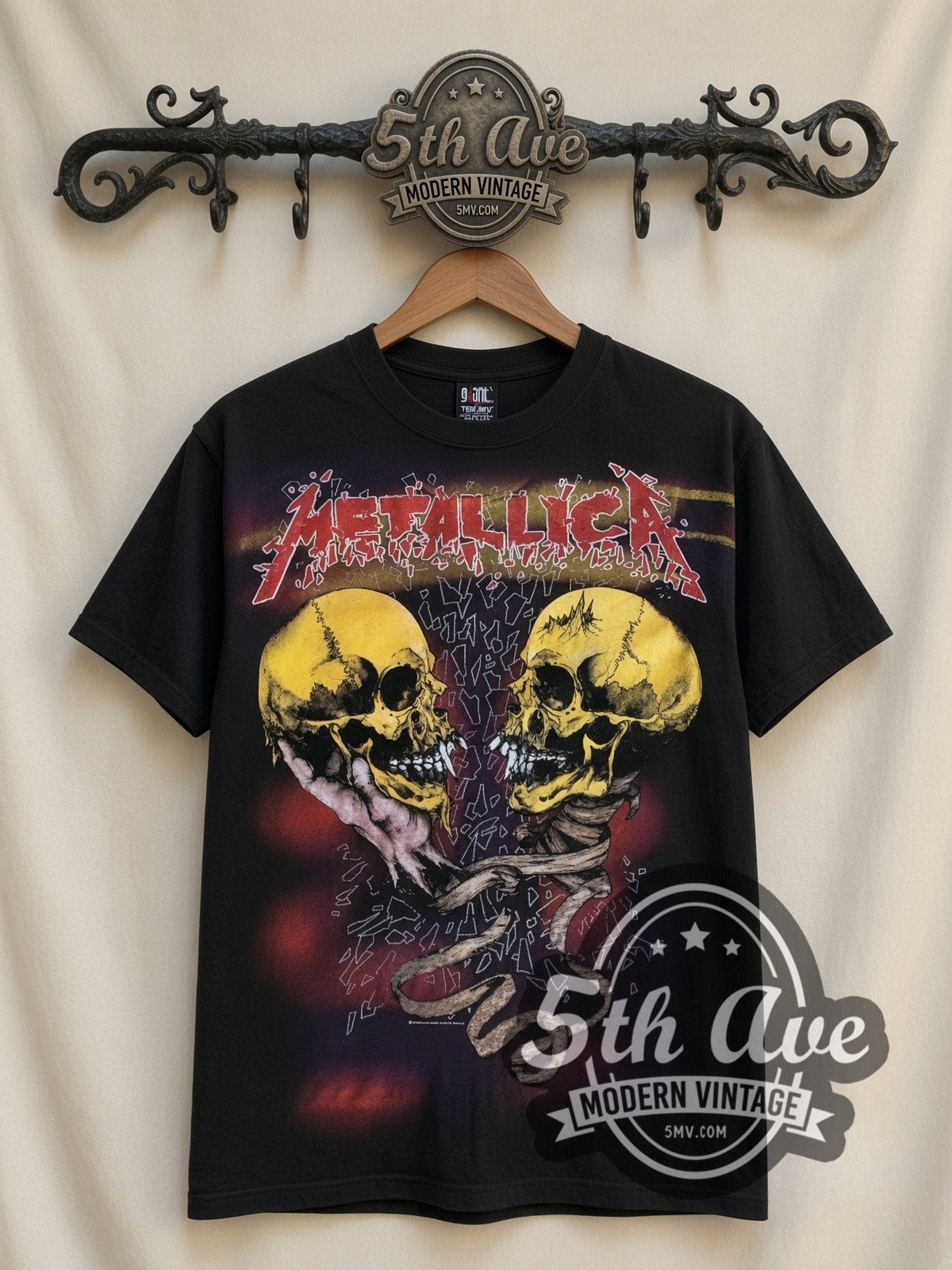 Metallica Dual Skulls Snake all-over-print vintage band t-shirt in black, front view on a display rack