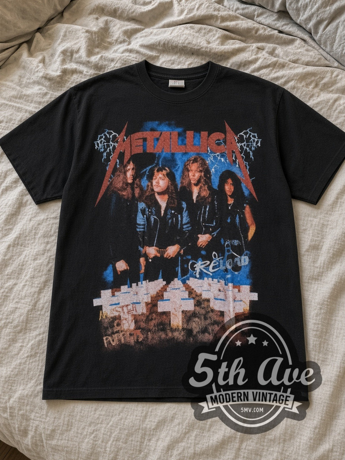 Black Metallica Reload Vintage Band T-Shirt laid flat on a linen bed