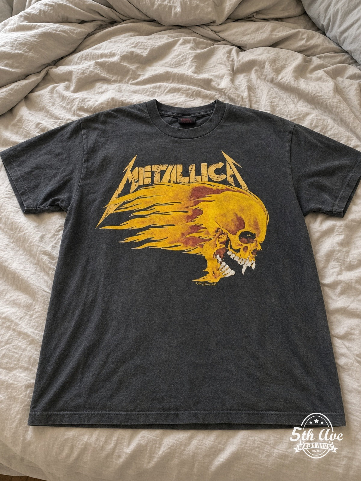 Metallica Summer Shit 94 Flaming Skull vintage tee laid on bed