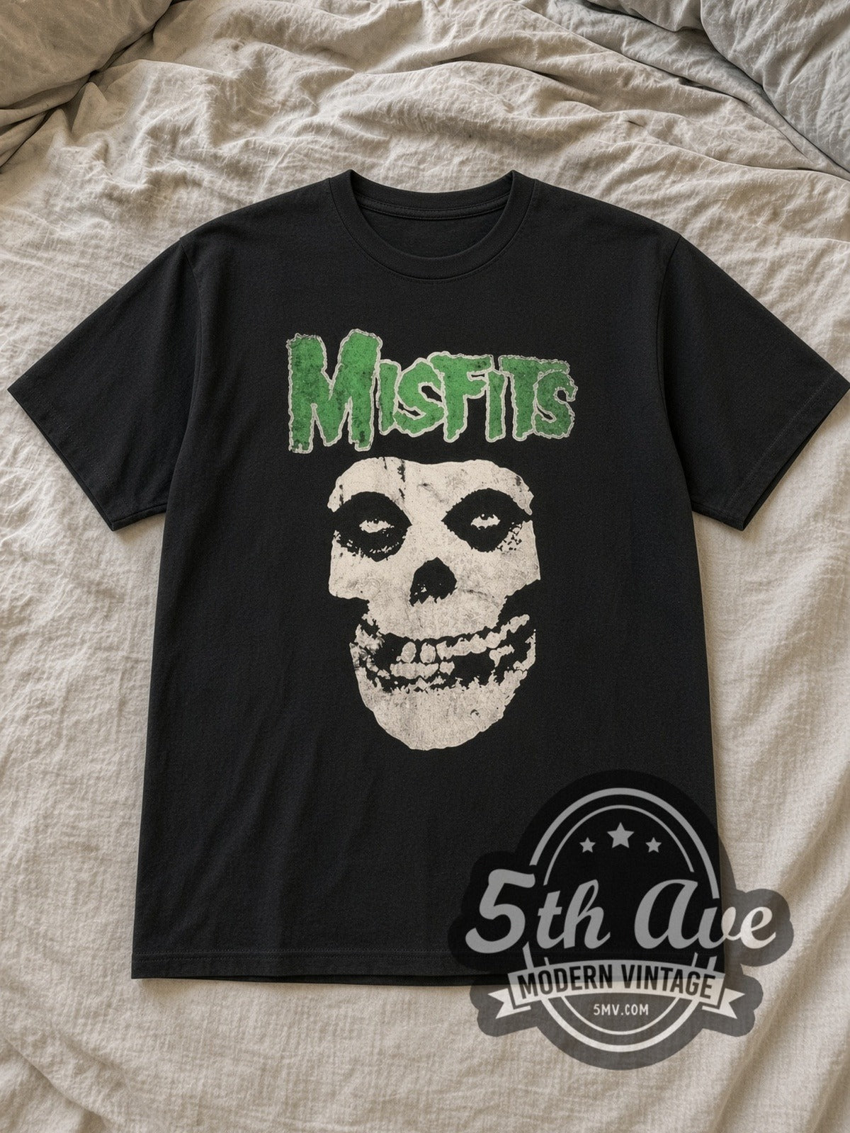 Black Misfits Green Logo Crimson Ghost Skull Vintage Band T-Shirt laid flat on a linen bed