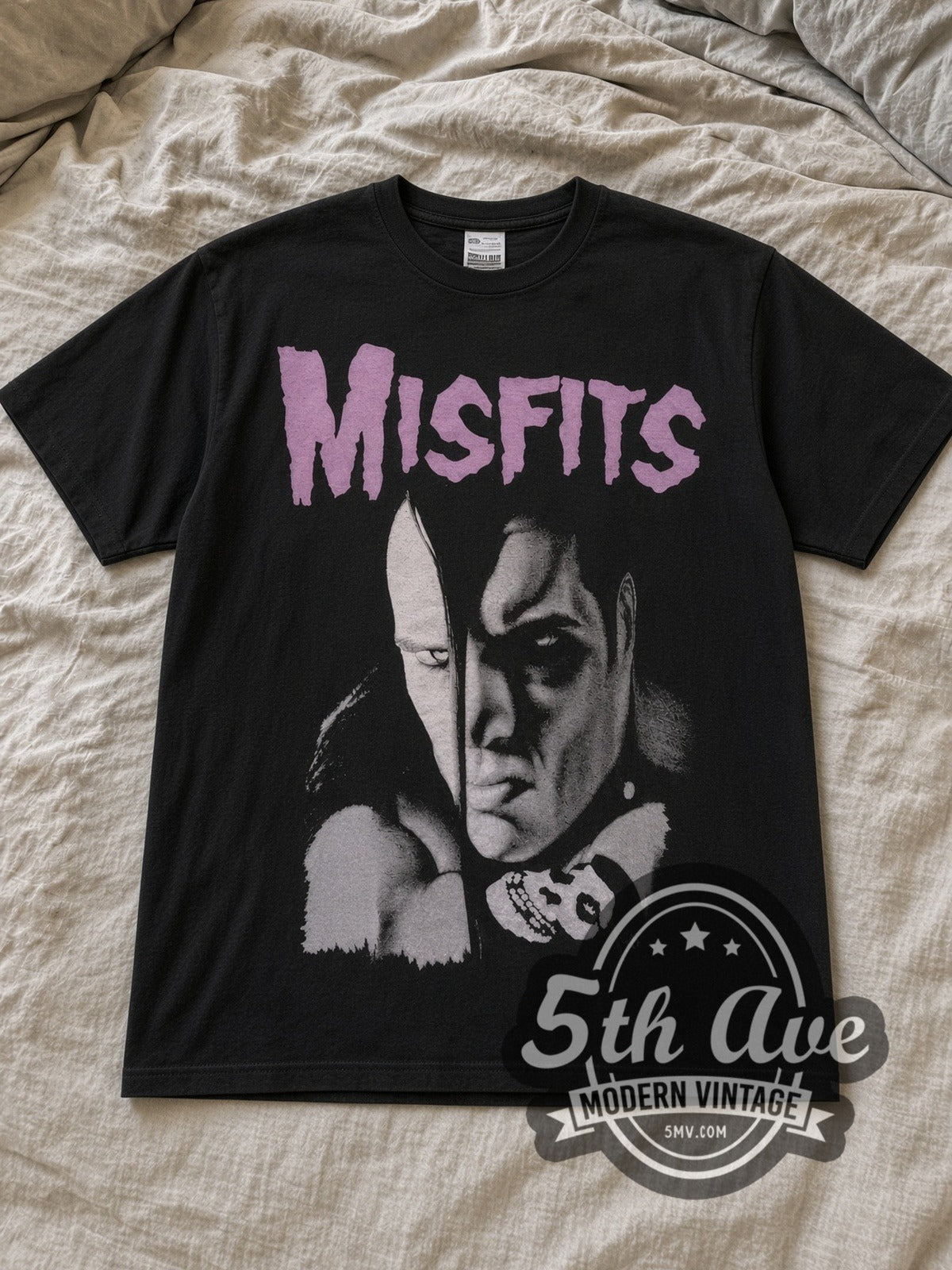 Black Misfits Split Face Portrait Vintage Band T-Shirt laid flat on a linen bed