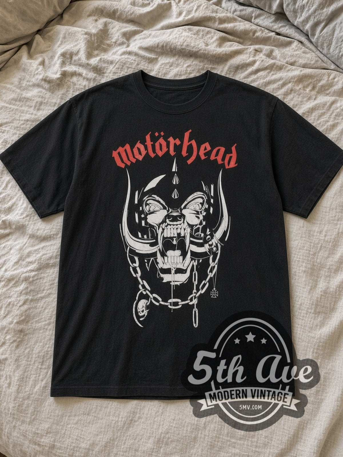 Black Motörhead Snaggletooth Red Logo and Chains Vintage Band T-Shirt laid flat on a linen bed