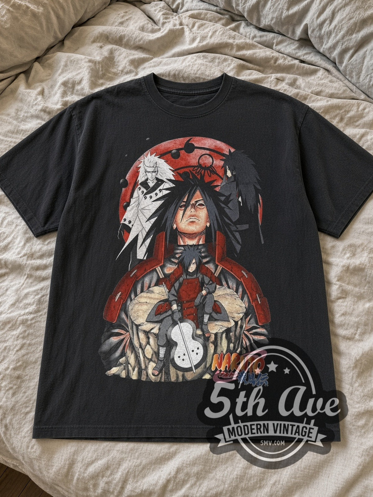 Black Naruto Madara anime tee laid flat on linen bed
