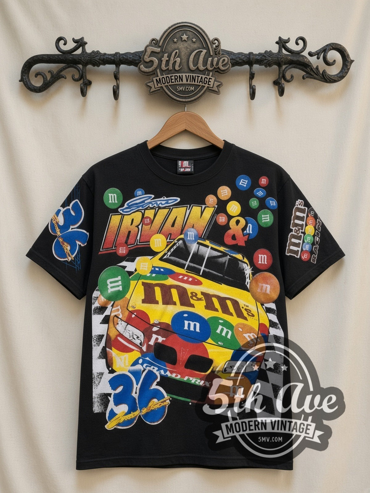 NASCAR Ernie Irvan #36 M&M's Racing all-over-print vintage NASCAR t-shirt in black, front view on a display rack