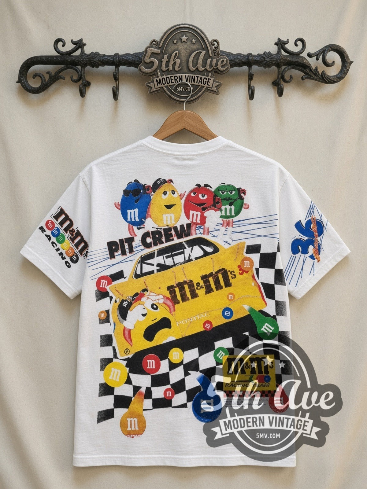 NASCAR Ernie Irvan #36 M&M's Racing all-over-print vintage NASCAR t-shirt in white, back view on a display rack