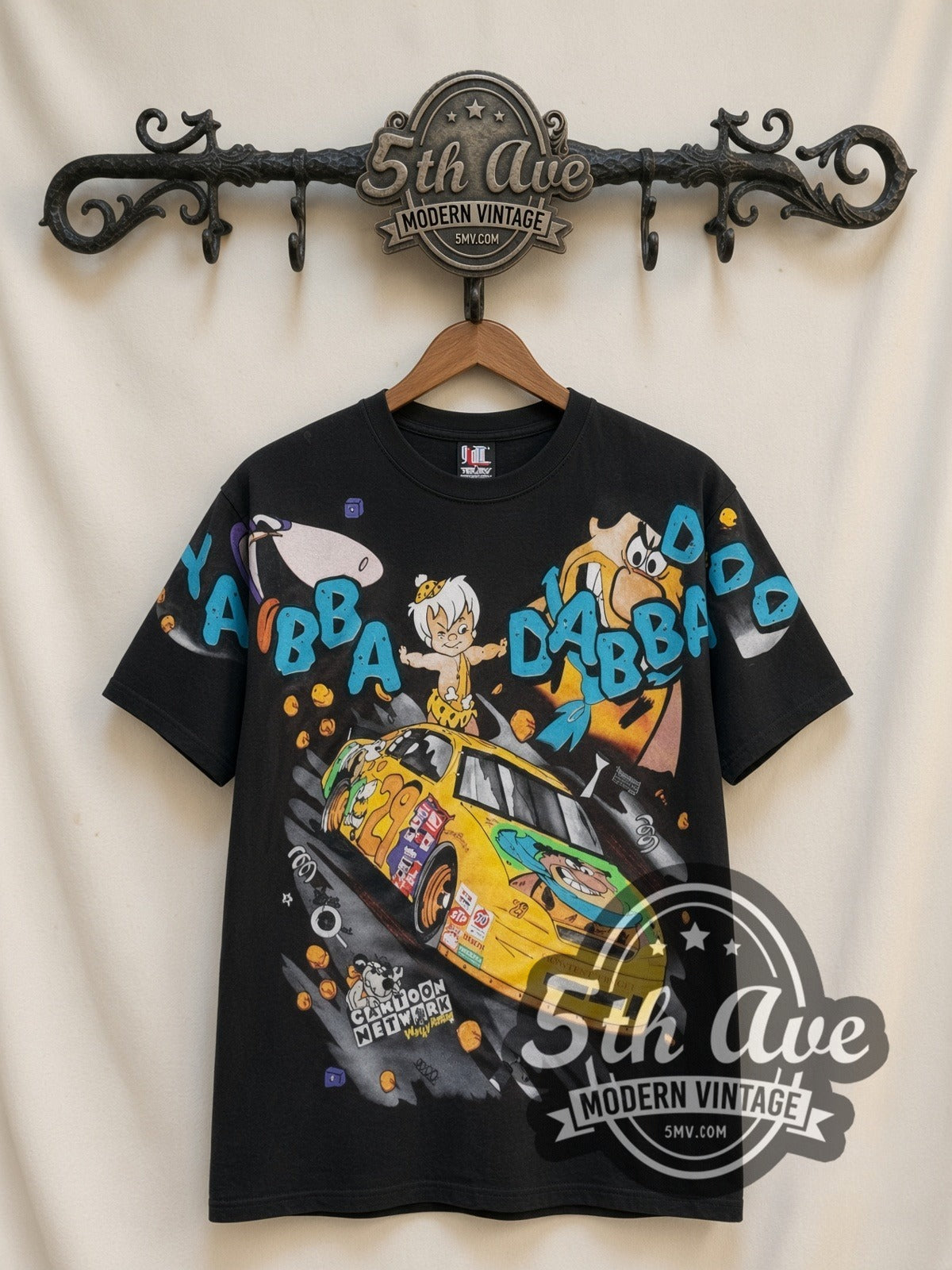 NASCAR Flintstones Yabba Dabba Doo Racing all-over-print vintage NASCAR t-shirt in black, front view on a display rack