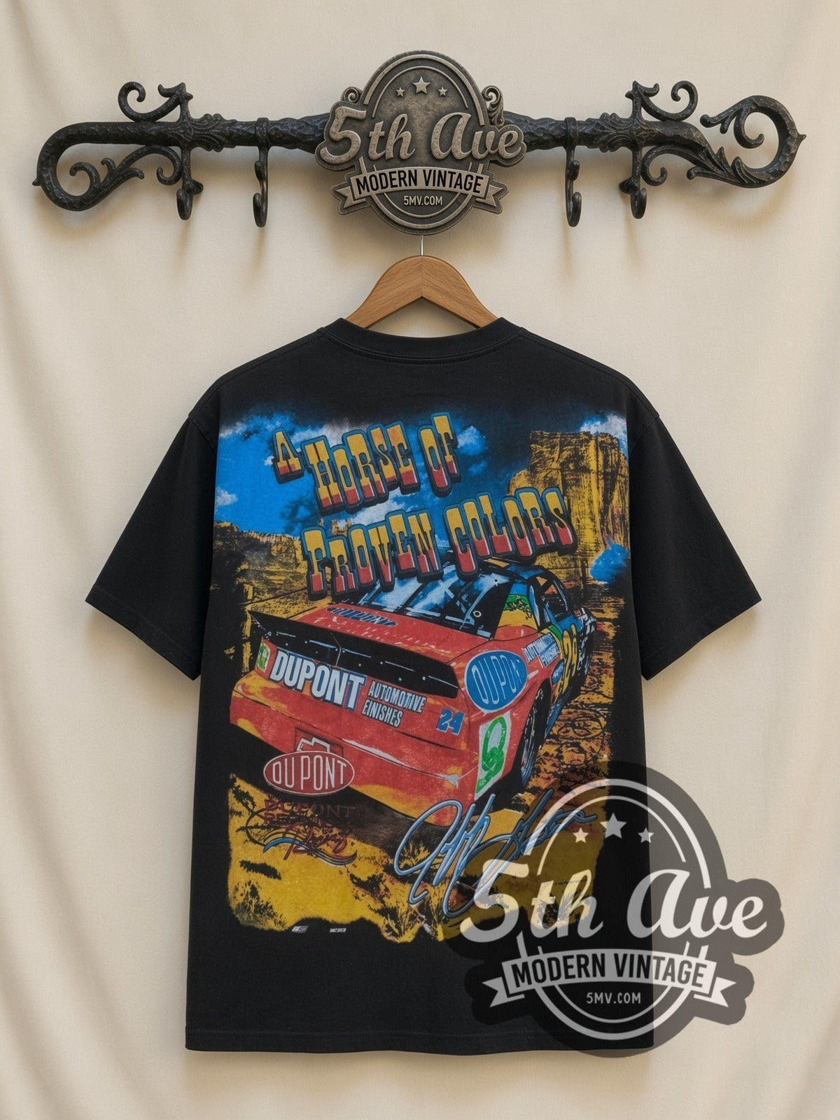 NASCAR Jeff Gordon #24 How The West Was Won all-over-print vintage NASCAR t-shirt in black, back view on a display rack