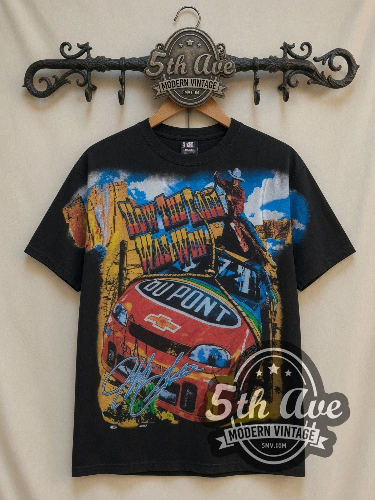 NASCAR Jeff Gordon #24 How The West Was Won all-over-print vintage NASCAR t-shirt in black, front view on a display rack