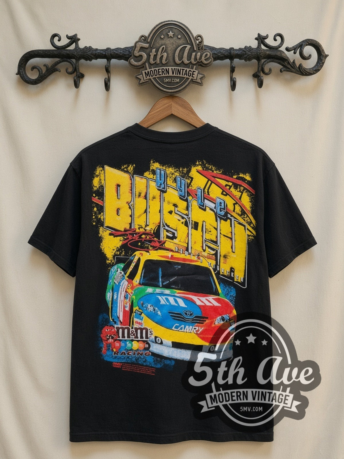 NASCAR Kyle Busch #18 M&M's Block Name all-over-print vintage NASCAR t-shirt in black, back view on a display rack
