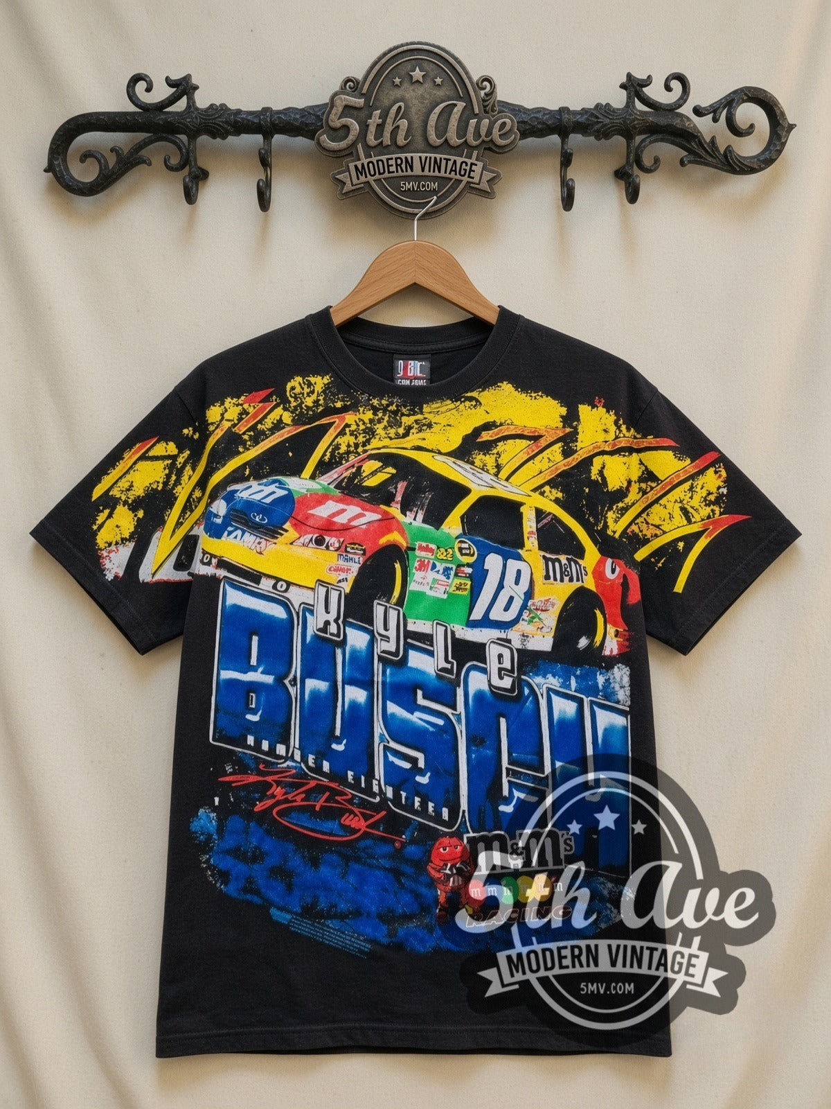 NASCAR Kyle Busch #18 M&M's Block Name all-over-print vintage NASCAR t-shirt in black, front view on a display rack