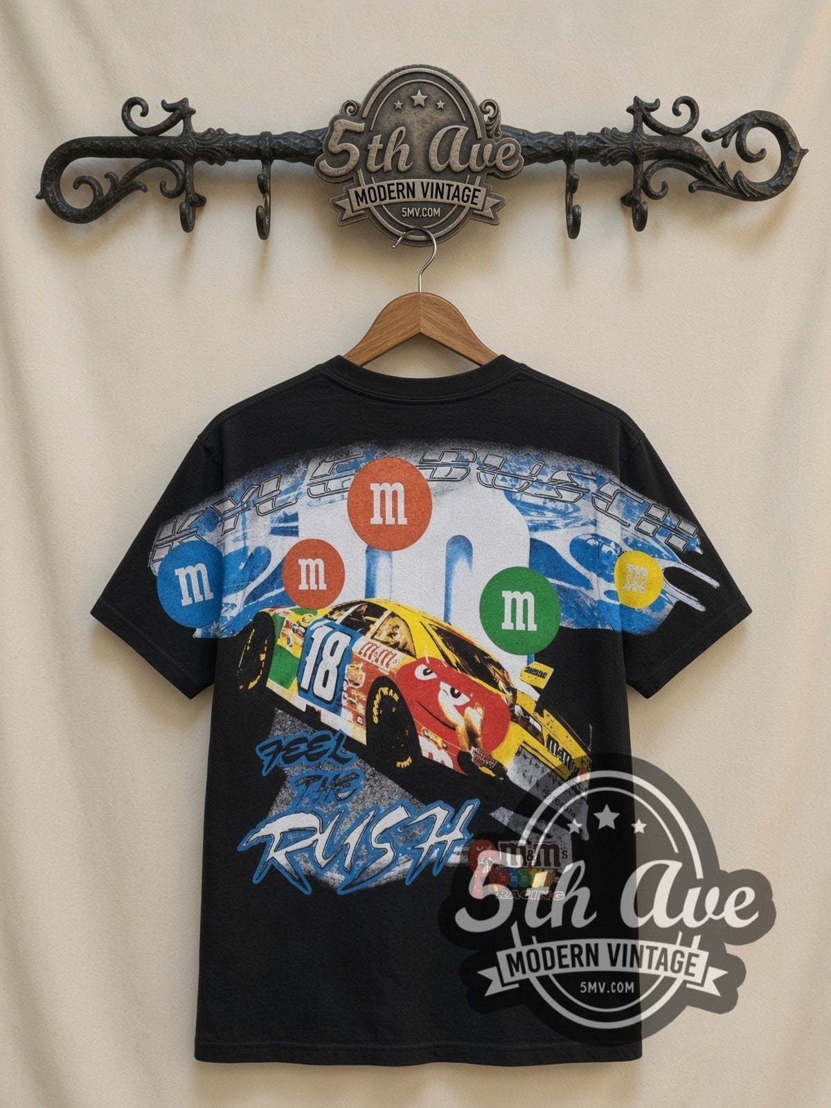 NASCAR Kyle Busch #18 M&M's Characters all-over-print vintage NASCAR t-shirt in black, back view on a display rack