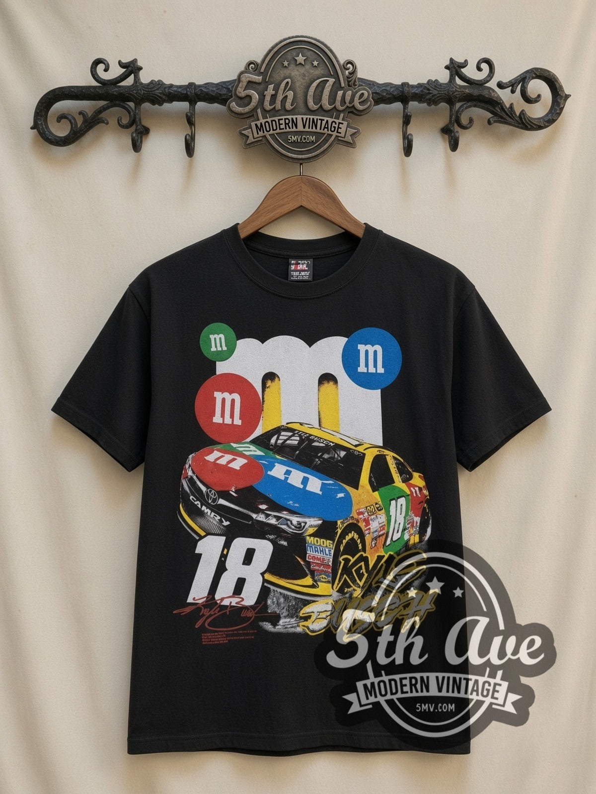 NASCAR Kyle Busch #18 M&M's Characters all-over-print vintage NASCAR t-shirt in black, front view on a display rack