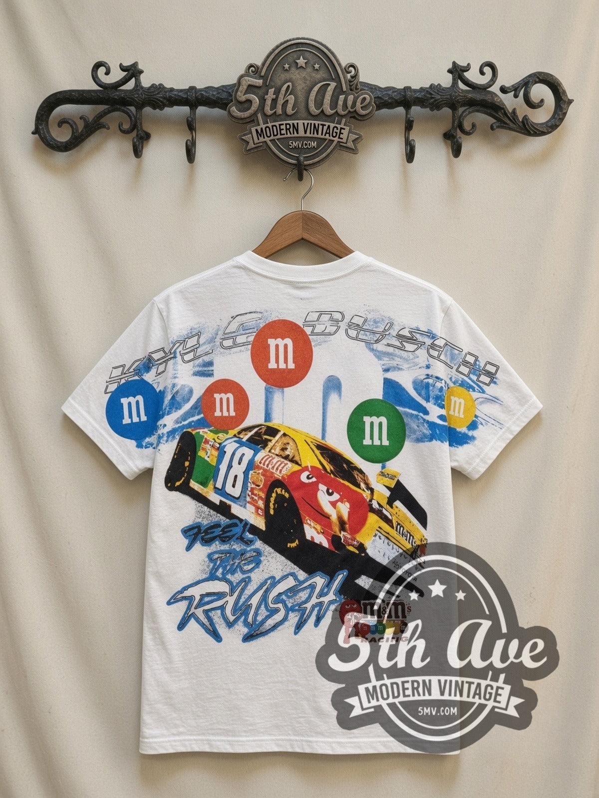 NASCAR Kyle Busch #18 M&M's Characters all-over-print vintage NASCAR t-shirt in white, back view on a display rack