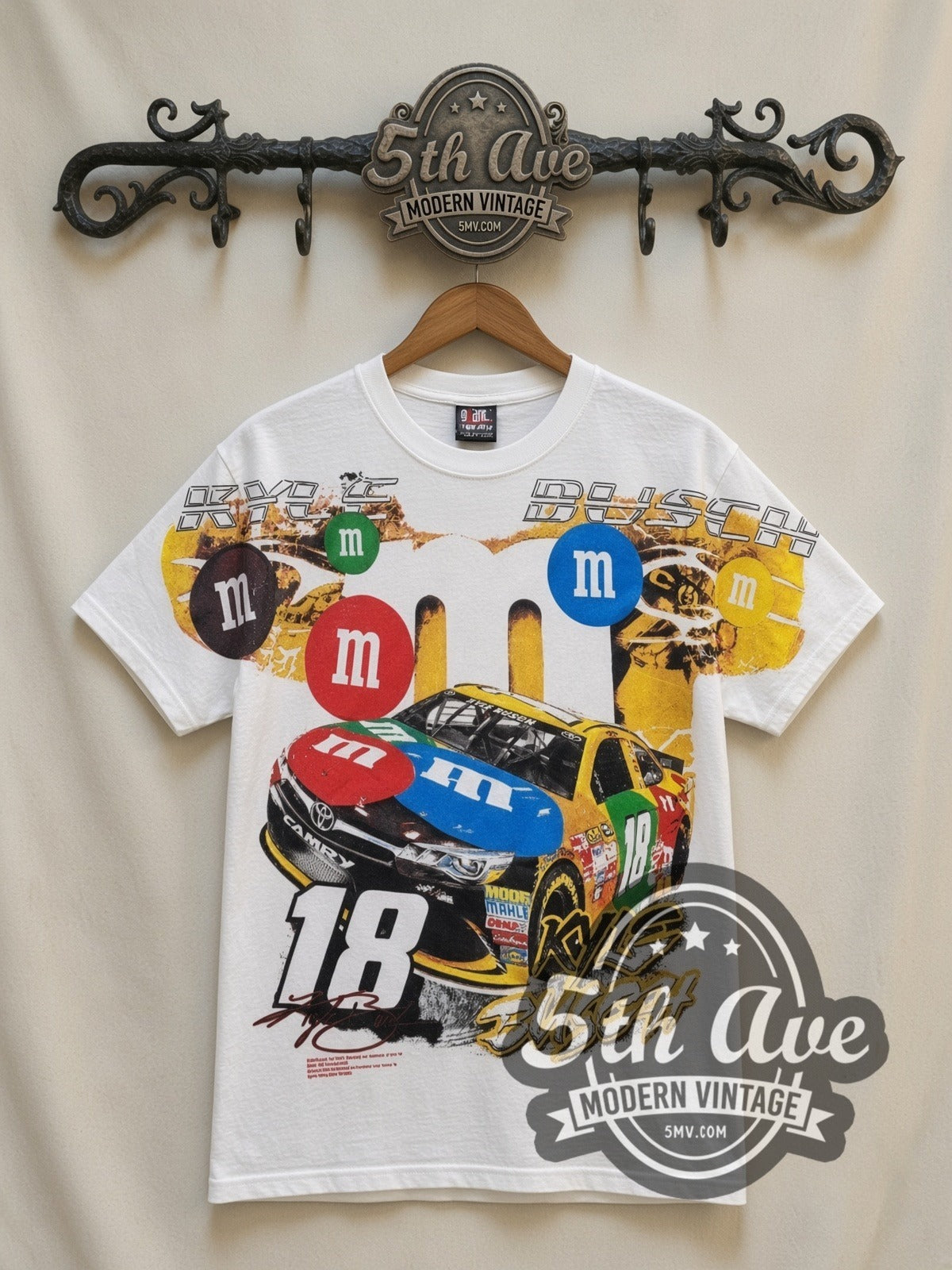 NASCAR Kyle Busch #18 M&M's Characters all-over-print vintage NASCAR t-shirt in white, front view on a display rack
