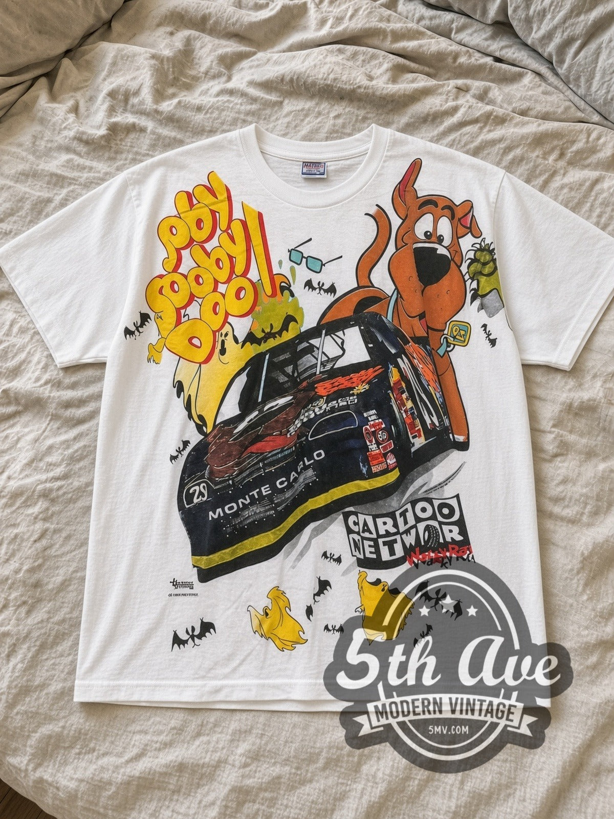 White Scooby Doo NASCAR Monte Carlo Mysteries Vintage NASCAR T-Shirt laid flat on a linen bed