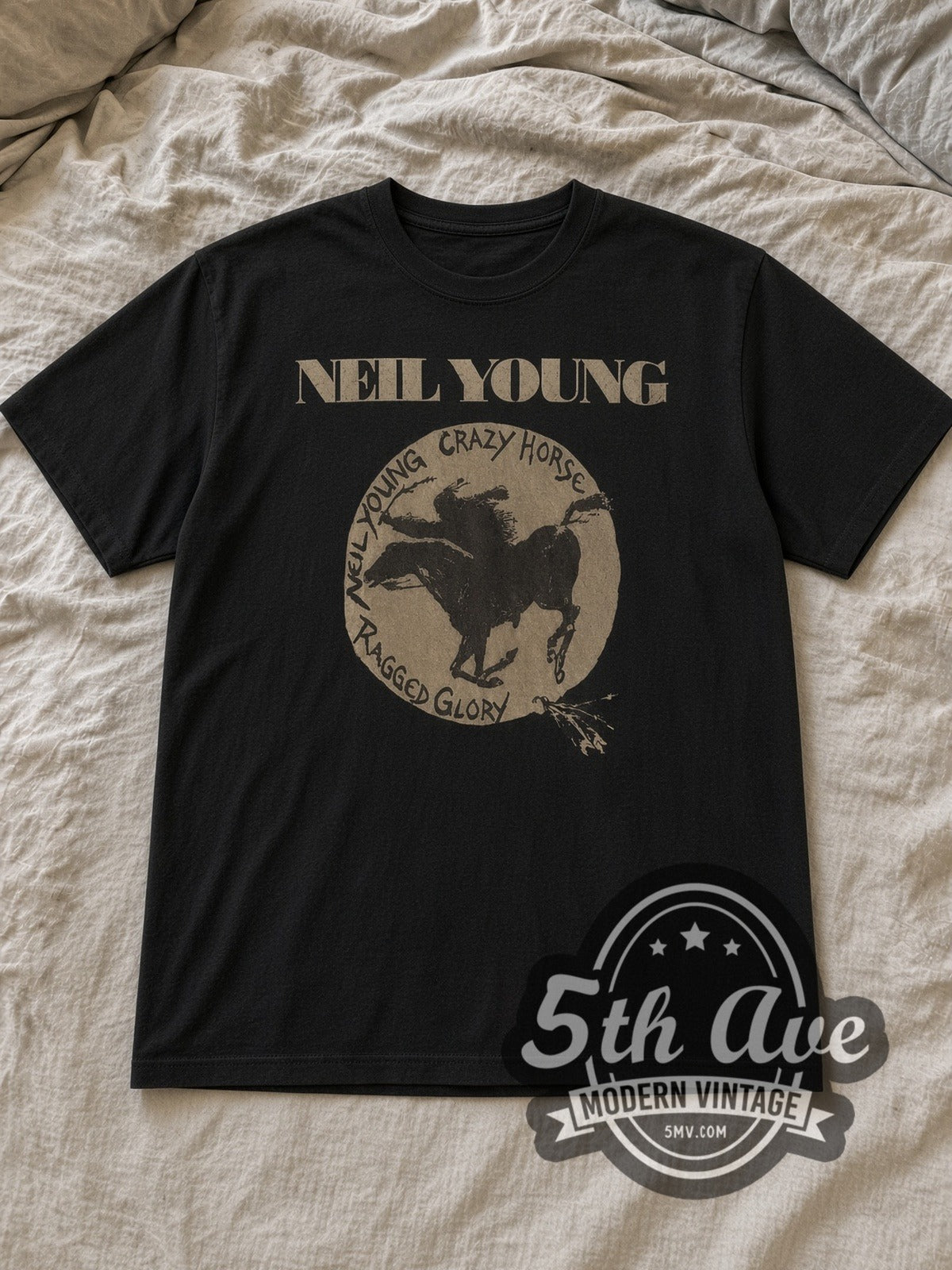 Black Neil Young Ragged Glory Crazy Horse Circle Vintage Band T-Shirt laid flat on a linen bed