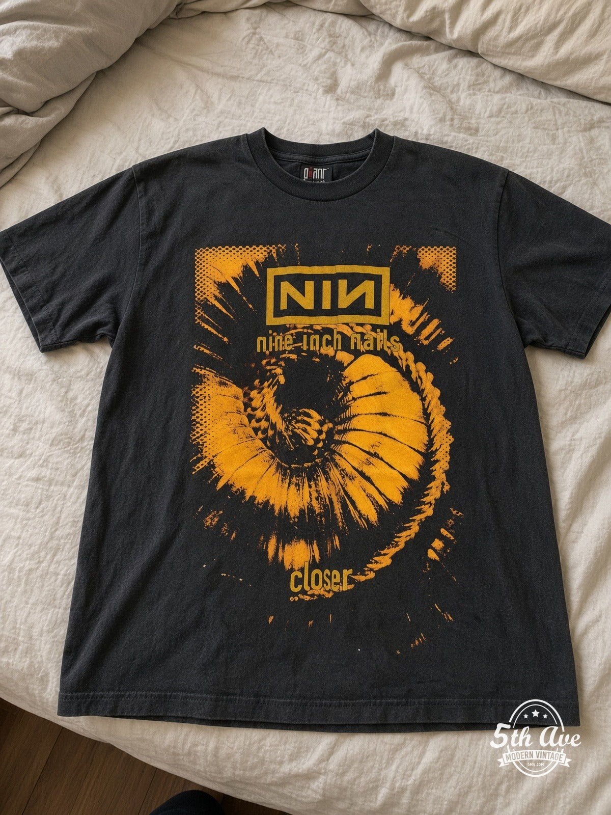 Nine Inch Nails Closer Downward Spiral vintage tee laid on bed