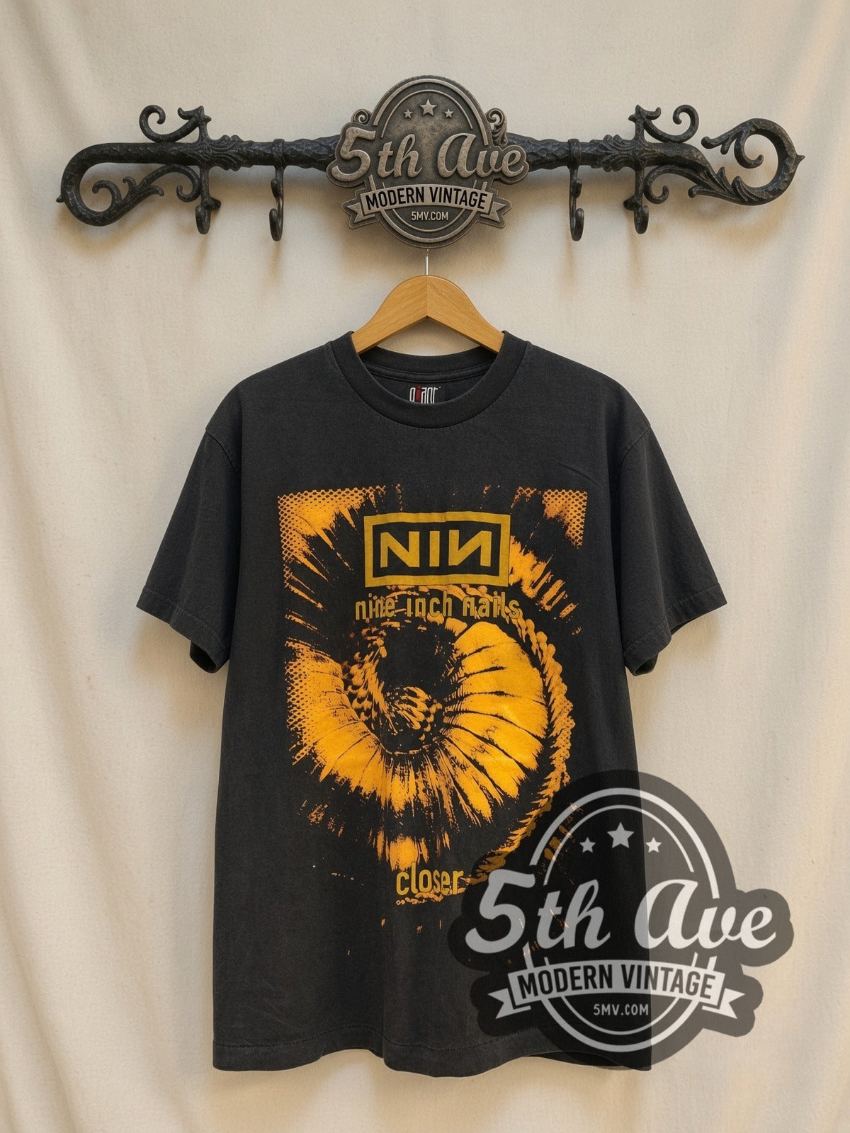 Nine Inch Nails Closer / Downward Spiral vintage band t-shirt, front view on a display rack