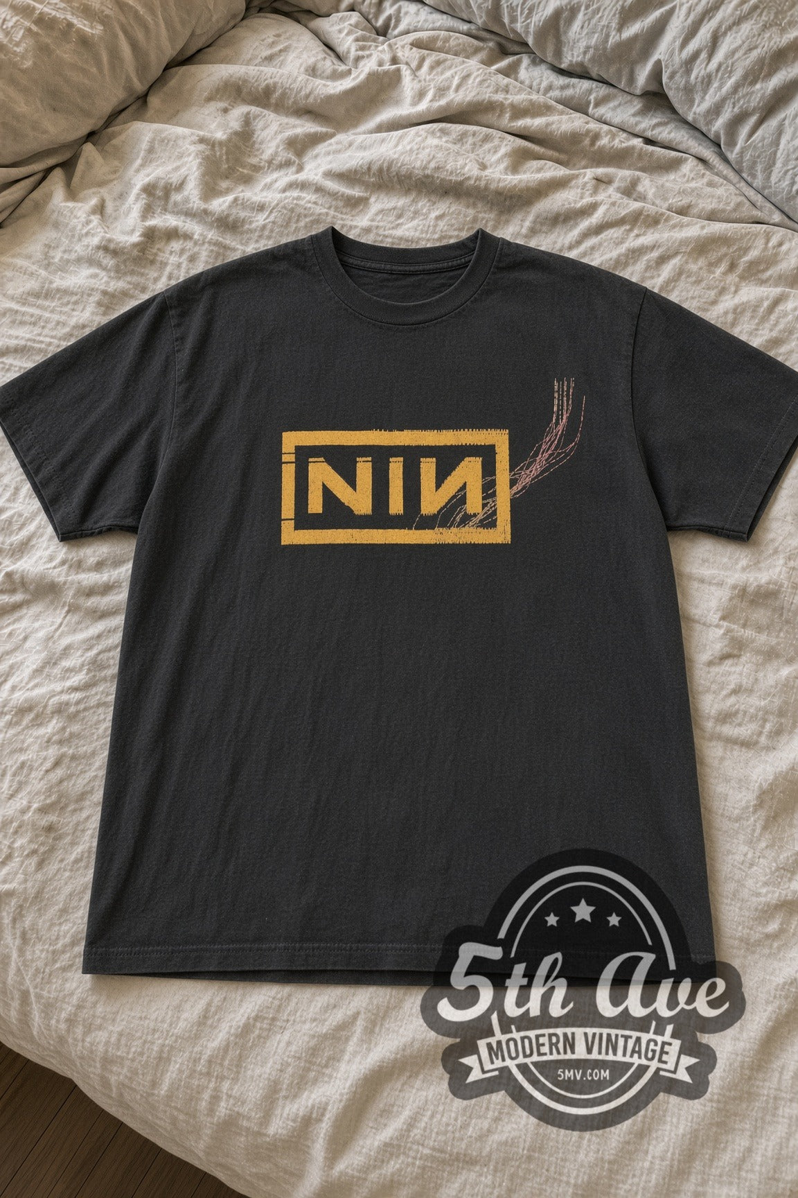 Nine Inch Nails Gold Boxed NIN Logo Scratch Lines vintage band t-shirt laid flat on bed