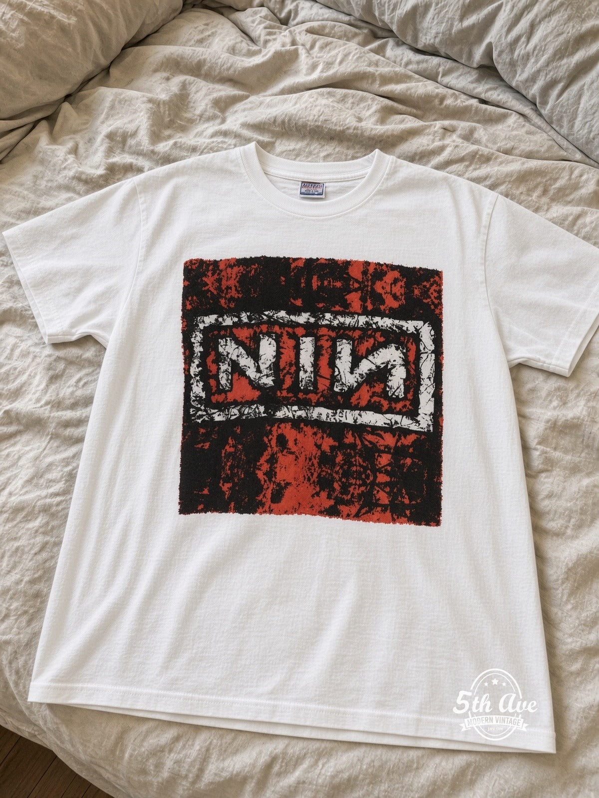 Nine Inch Nails In Concert Trent Crouch White Body vintage tee laid on bed