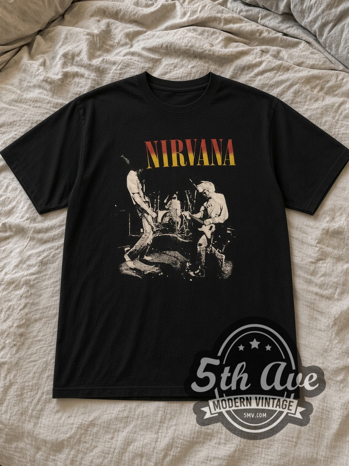 Black Nirvana Live Stage Photo Red Yellow Logo Vintage Band T-Shirt laid flat on a linen bed