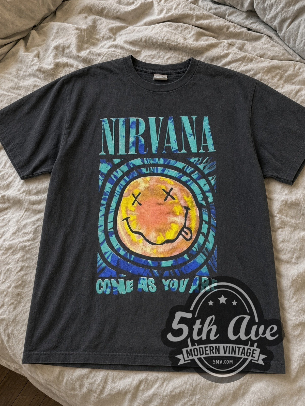 Faded black Nirvana Come As You Are Psychedelic Smiley & Box Logo tee laid flat on linen bed
