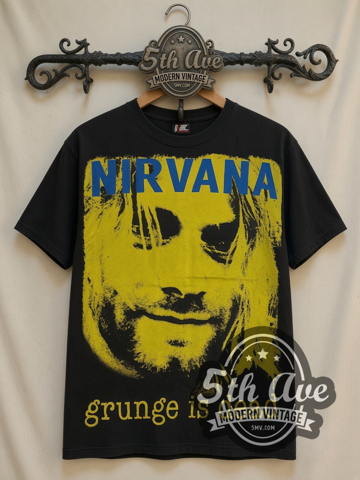 Nirvana Grunge Is Dead Yellow Kurt all-over-print vintage band t-shirt in black, front view on a display rack