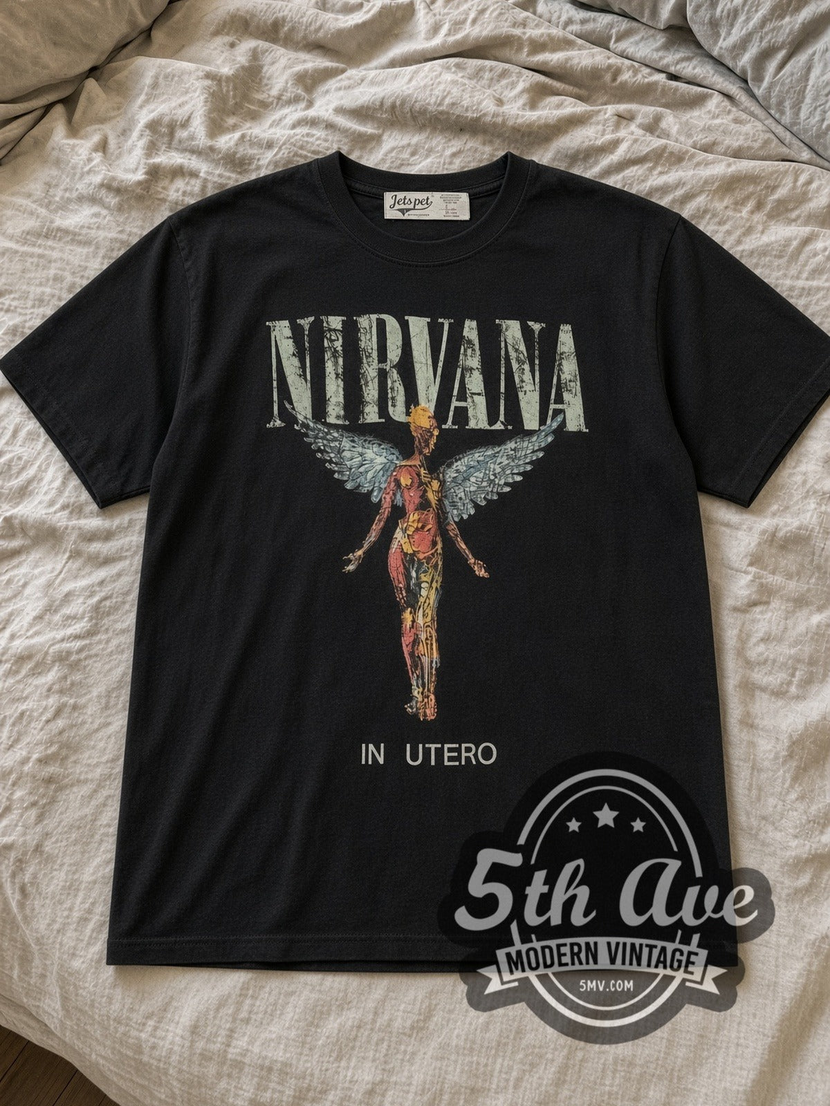 Black Nirvana In Utero Stone Wash Anatomical Angel Vintage Band T-Shirt laid flat on a linen bed