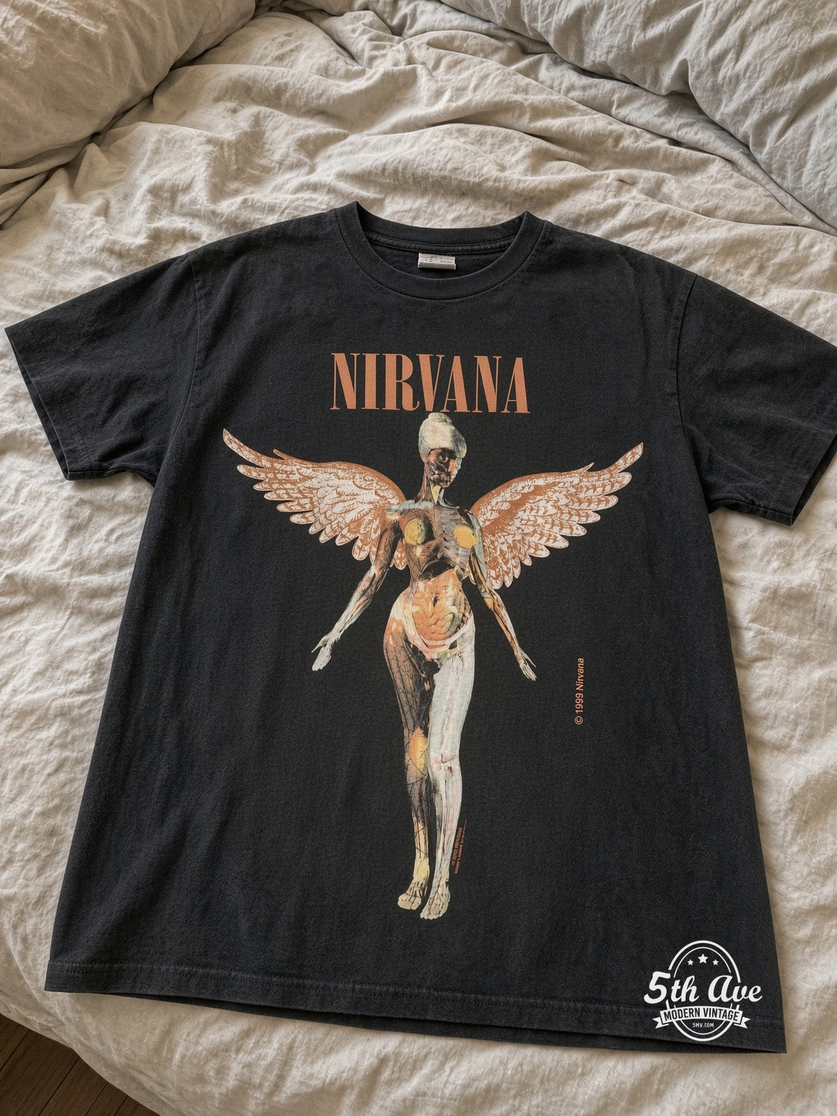 Nirvana In Utero Anatomical Angel Peach vintage tee laid on bed