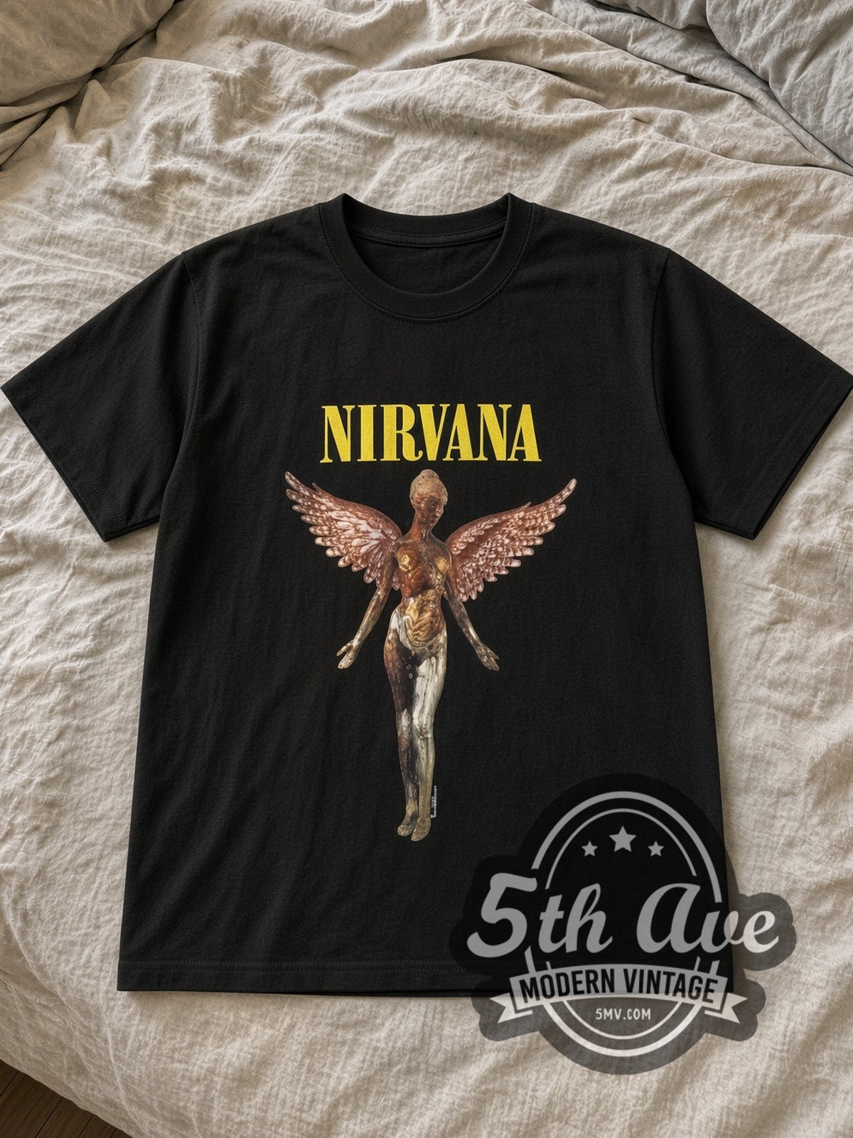 Nirvana In Utero Angel band t-shirt in black laid flat on a bed, front artwork