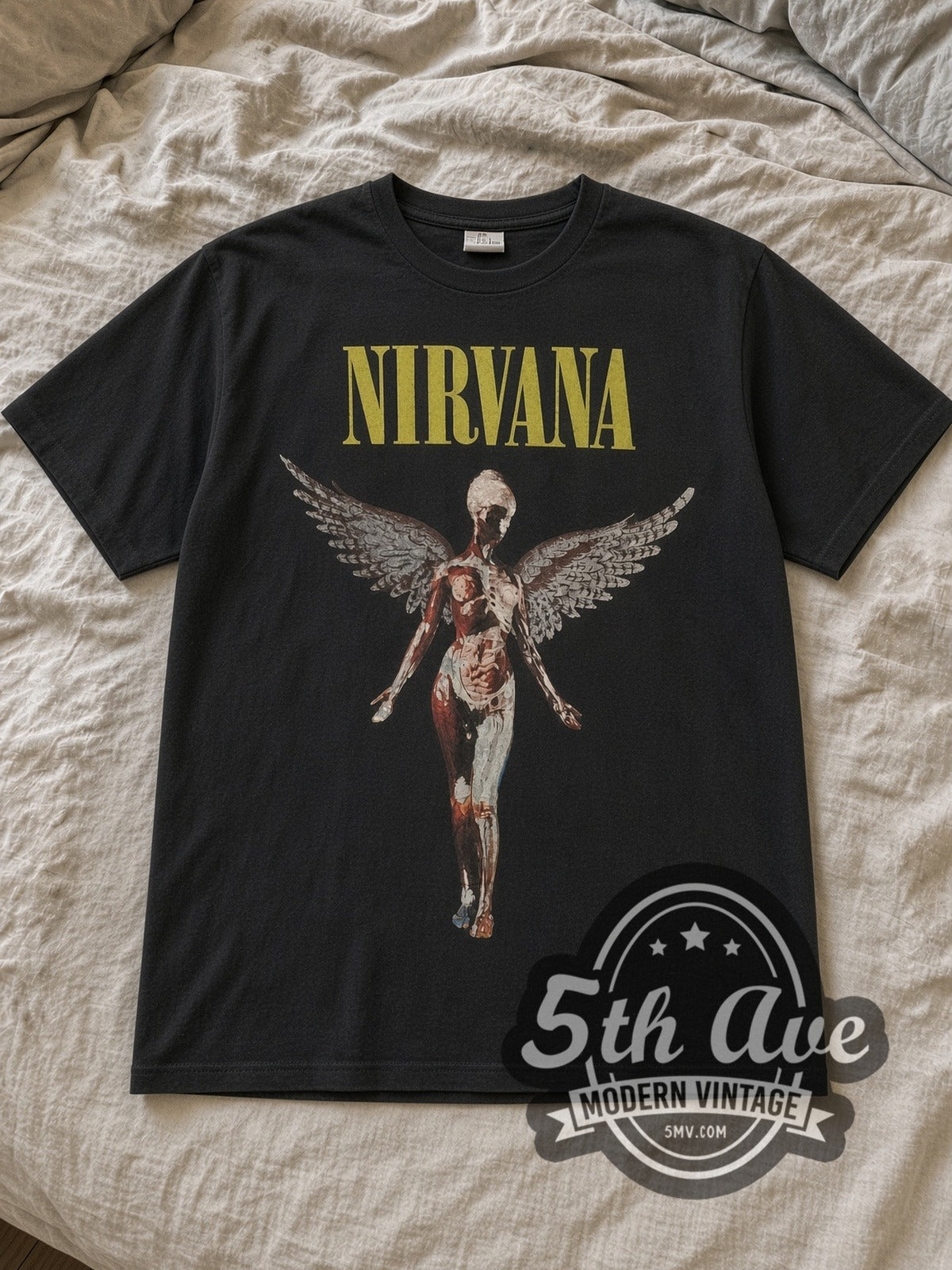 Black Nirvana In Utero Angel with Back Print Vintage Band T-Shirt laid flat on a linen bed