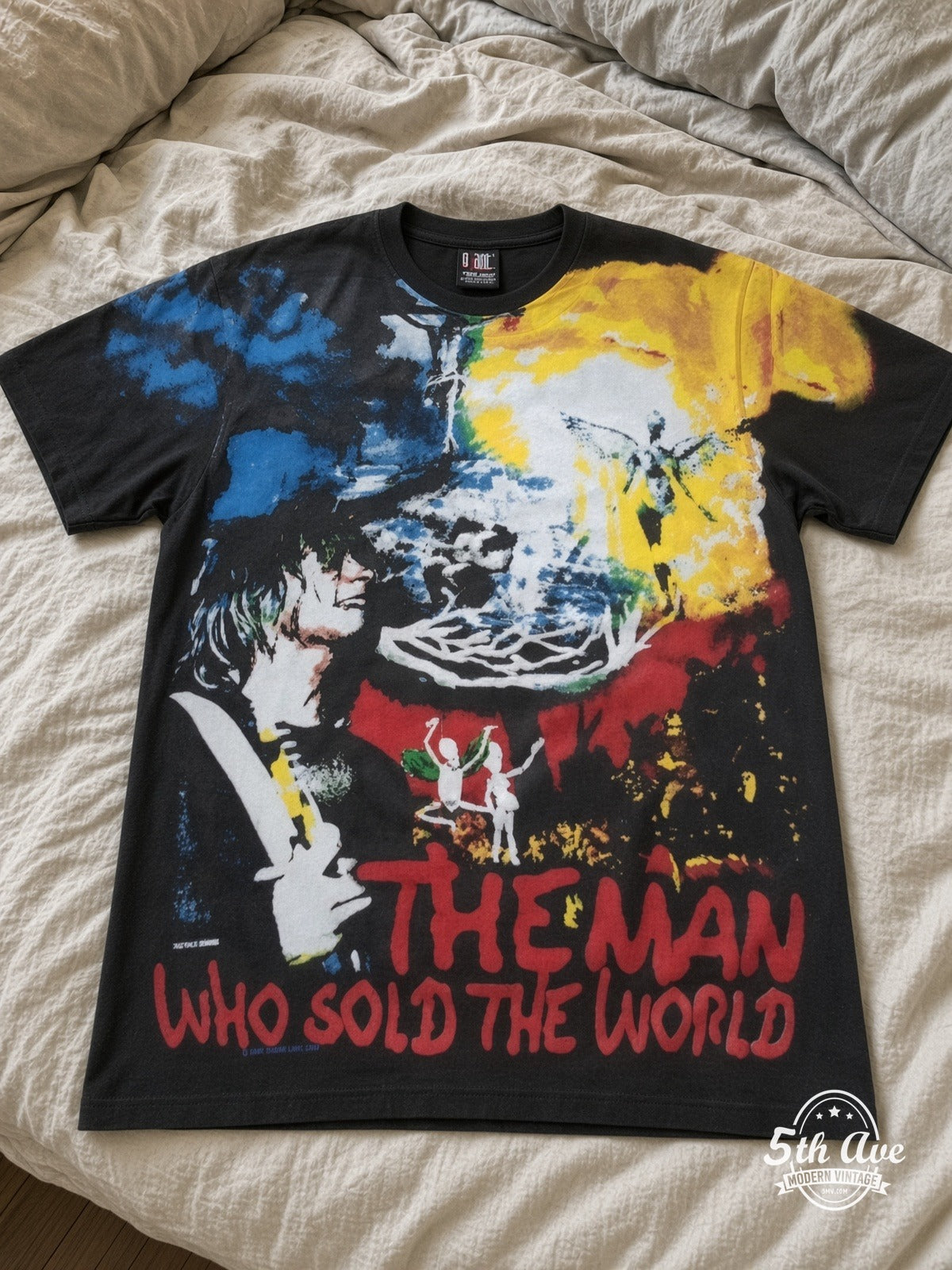 Nirvana Man Who Sold The World Black all over print vintage tee laid on bed