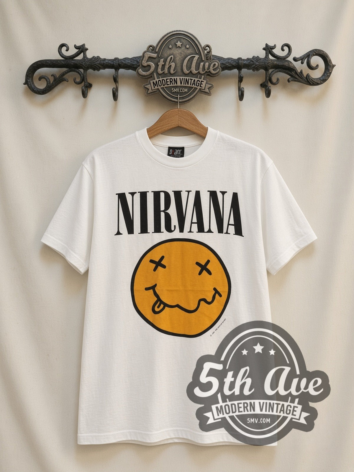 Nirvana Yellow Smiley / Butthole Surfers vintage band t-shirt, front view on a display rack