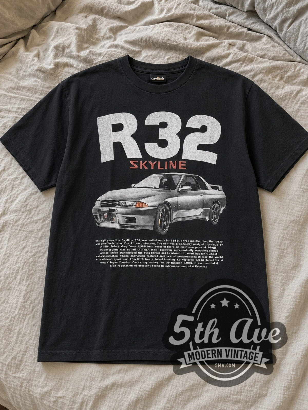 Black Nissan Skyline R32 Vintage Motorsports T-Shirt laid flat on a linen bed