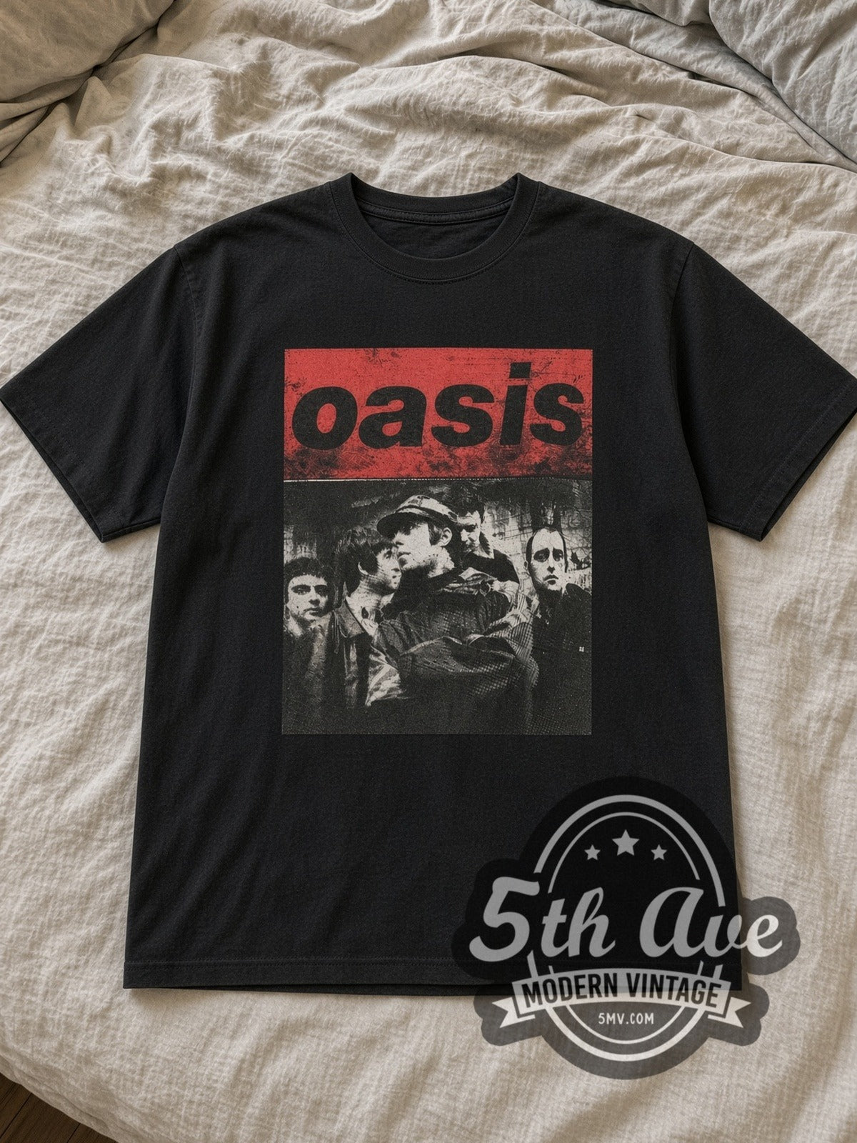 Black Oasis Band Image Vintage Band T-Shirt laid flat on a linen bed
