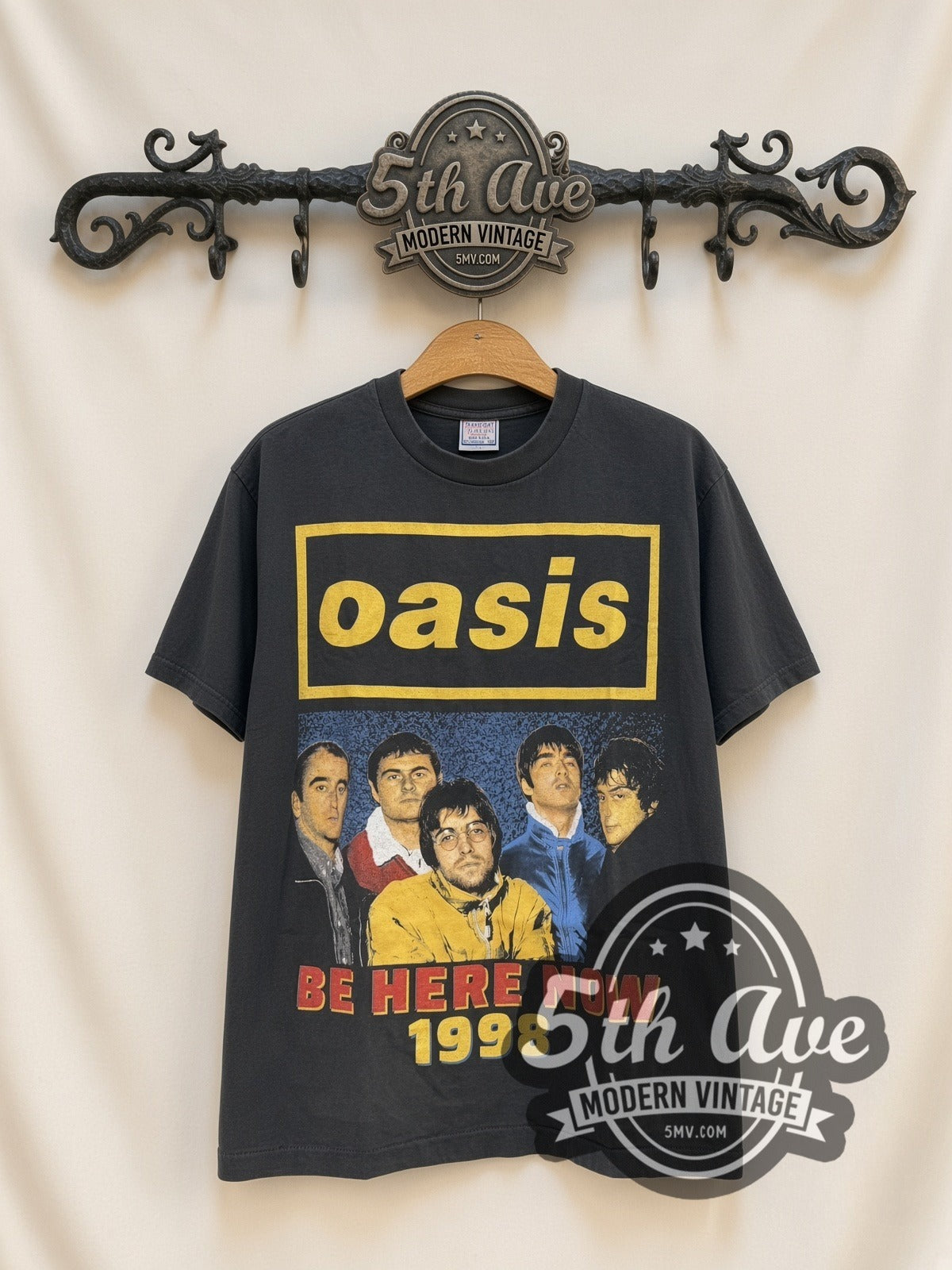 Oasis Be Here Now Tour 1998 vintage band t-shirt, front view on a display rack